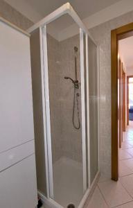a shower with a glass door in a bathroom at Trilo La Rindela in Folgaria