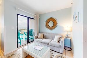 a living room with a couch and a table at Plantation Dunes #5101 in Gulf Shores