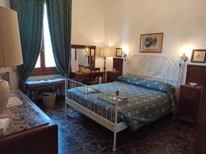 a bedroom with a bed and a chair and a window at Rooms by Anna in Florence