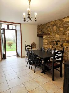 a dining room with a table and chairs at Chambre d'hôte Manoir de La Baudonnière in Monsireigne
