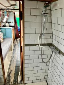 a shower in an rv with white subway tiles at The Sitting Duck in Greet +54 photos