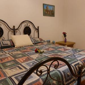 a bedroom with a bed with a quilt on it at Camera "La Margherita" in Pistoia
