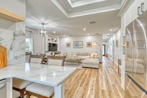 a kitchen and living room with a white table at Waterfront Family Vacation , Near Ocean and Mineral Springs, 7 sleeps in Rotonda West