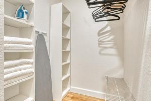 a walk in closet with white shelves and towels at Waterfront Family Vacation , Near Ocean and Mineral Springs, 7 sleeps in Rotonda West +38 photos