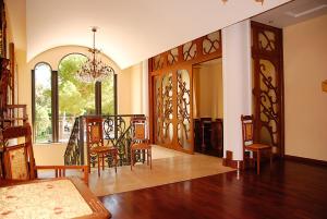 a living room with a table and chairs and a dining room at Hotel Giardino Inglese in Palermo