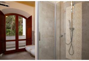 a bathroom with a shower and a toilet at Villa Talia Sweet Rooms B&B in Ischia +55 photos