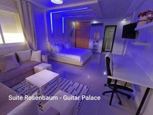 a living room with a couch and a table at Chambres d'hôtes - Écohâme - Guitar Palace in Ouazzane
