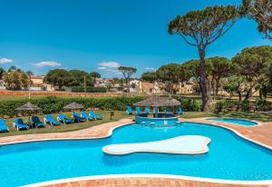 a swimming pool with a slide in a resort at Browns Sports Resort in Vilamoura