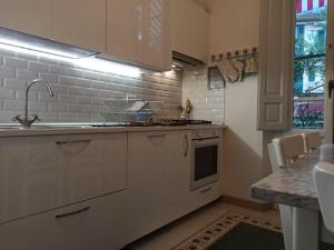 a kitchen with white cabinets and a sink at Rooms by Anna in Florence +87 photos