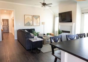 a living room with a couch and a table at Luxury Home Near Kyle Field & Expo Center in Bryan