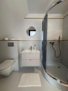 a bathroom with a sink and a shower and a toilet at Polanki 22 in Łeba +55 photos