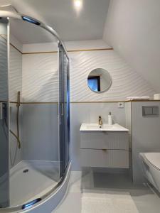 a bathroom with a shower and a sink at Polanki 22 in Łeba +63 photos