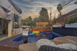 a swimming pool with toys in it in a backyard at villa white hall in Yehud