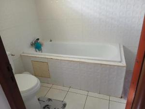 a bathroom with a white tub and a toilet at Maison spacieuse à Petit-Bourg avec jardin in Petit-Bourg +28 photos