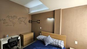 a room with a bed and a desk and a television at A25 Premium Suite WHITE Cocina Terraza Companies Work Teams 1-2 PAX in Cuautitlán Izcalli