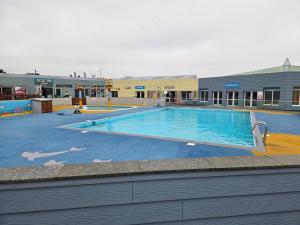 a large swimming pool in front of a building at Mullion Holiday Park, Lizard Point in Mullion