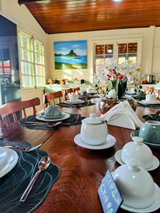 a wooden table with china on top of it at Pousada Liberty Noronha in Fernando de Noronha +61 photos