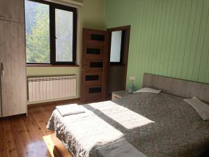 a bedroom with a bed in a room with green walls at Istisu Valley Spa in İsmayıllı +69 photos