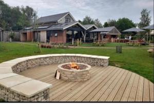 a fire pit on a deck in a yard at Willow Warbler - HM112 - Lower Mill Estate Penthouse Apartment with Spa Access in Somerford Keynes