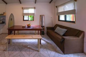 a living room with a couch and a table at The Cafecito Surfhouse - Santa Teresa in Santa Teresa Beach +36 photos