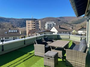 a patio with a table and chairs on a roof at Ferienwohnung Am Schiff in Eberbach in Eberbach