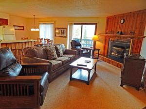 a living room with a couch and a fireplace at Timber Run in Winter Park