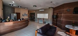 a waiting room with a couch and a bar at Hotel Parati in Parapuã +42 photos