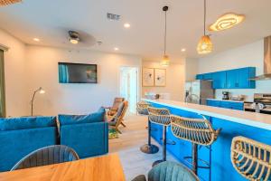 a living room with a bar and a kitchen at Indigo Sea Escape in South Padre Island