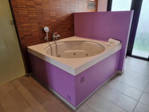 a purple bath tub in a bathroom at Apartamentos El Arrecife in Conil de la Frontera +78 photos