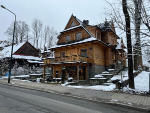 a wooden house on the side of the street at Katmandu in Zakopane