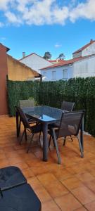 a table and two chairs on a patio at Apartamentos Corea in Portonovo