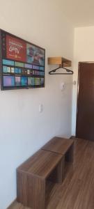 a table in a room with a tv on the wall at Suites Duarte in Ouro Preto +142 photos