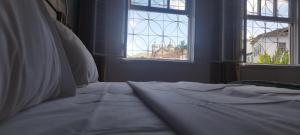a white bed in a room with a window at Suites Duarte - Centro Histórico in Ouro Preto +162 photos