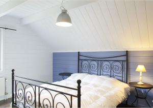 a bedroom with a bed and a lamp and a table at La maison du sourire 2 in Durbuy
