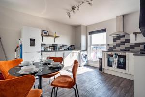 a kitchen and dining room with a table and chairs at Captains Quarters in Cleethorpes