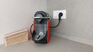 a black and red appliance plugged into a lightswitch at Appartamento La Bussola in Còvolo