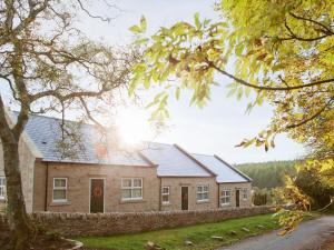 a house with a stone wall in front of it at Three The Old Stables in Knitsley +7 photos