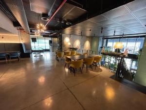 a restaurant with a table and chairs in a room at Sunny Spot Batumi in Batumi
