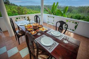 a table on the balcony of a house at Gold Cinnamon Villa in Egodaduwa