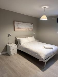 a bedroom with a large bed with a white bedspread at Great Northern Apartment in Aberdeen