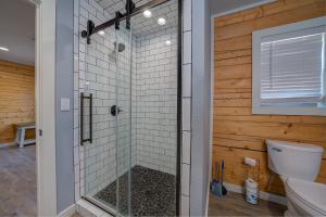 a bathroom with a shower with a toilet at Happy Times on Caddo River by StayLage in Glenwood +31 photos
