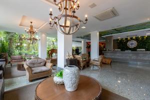a living room with a chandelier and a table at Amazon Plaza Hotel in Cuiabá