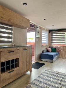 a living room with a couch and a window at Sonata Camp in Jastarnia