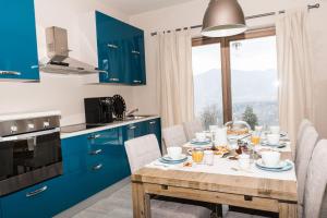 a kitchen with blue cabinets and a table with food on it at Lavanda e Rosmarino in Miasino