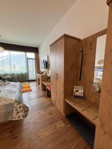 a bedroom with a bed and a wooden cabinet at Apartment Helena in Bad Goisern