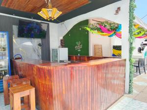 a bar in a restaurant with a wooden counter at HOSTAL PIAZZOLLA in Manta +51 photos
