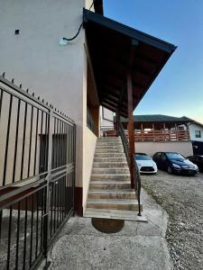 a staircase leading to a building with cars parked at Sasa Plus in Bajina Bašta