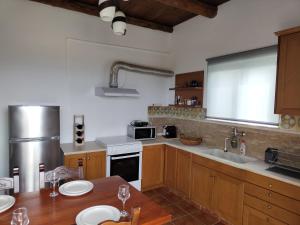 a kitchen with wooden cabinets and a table with plates on it at Sea Sight Vibes in Frangokastello