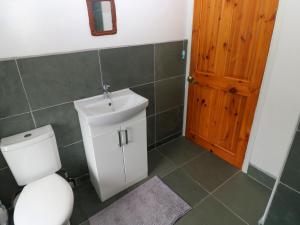 a bathroom with a toilet and a sink at 25 St James Street in Narberth +7 photos