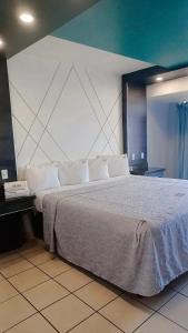 Postel nebo postele na pokoji v ubytování hotel paraiso